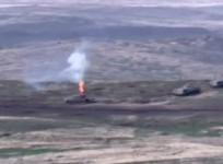 A still image from a video released by the Armenian Defence Ministry shows what is said to be Azerbaijani armoured vehicles, one of which is destroyed by Armenian armed forces in the breakaway region of Nagorno-Karabakh, in this still image from footage r