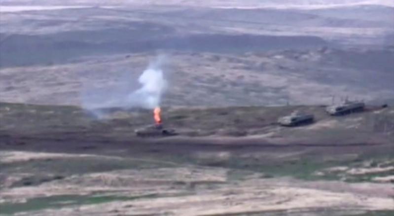 A still image from a video released by the Armenian Defence Ministry shows what is said to be Azerbaijani armoured vehicles, one of which is destroyed by Armenian armed forces in the breakaway region of Nagorno-Karabakh, in this still image from footage released September 27, 2020. Defence Ministry of Armenia/Handout via REUTERS A still image from a video released by the Armenian Defence Ministry shows what is said to be Azerbaijani armoured vehicles, one of which is destroyed by Armenian armed forces in the breakaway region of Nagorno-Karabakh, in this still image from footage r
