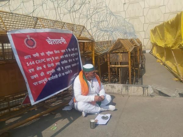 Farmers leader Rakesh Tikait having lunch near a police barricade at Ghazipur border Rakesh Tikait