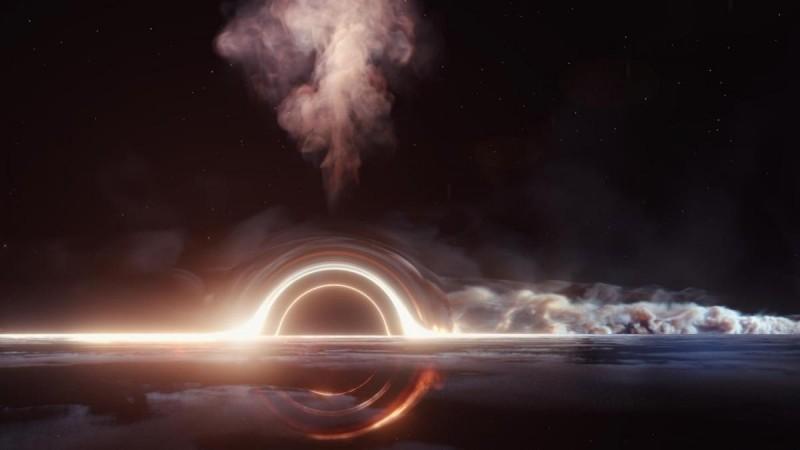 A view of the accretion disc around the supermassive black hole, with jet-like structures flowing away from the disc. The extreme mass of the black hole bends spacetime, allowing the far side of the accretion disc to be seen as an image above and below the black hole star