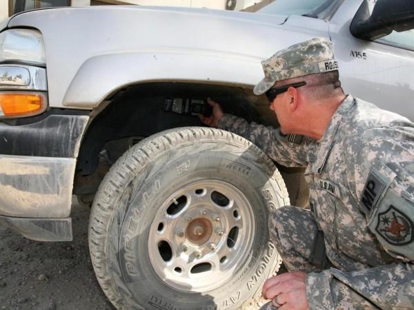 A US Army member of the Iraqi Police Transition Team demonstrates how a sticky bomb is typically placed on a vehicle. Sticky Bomb