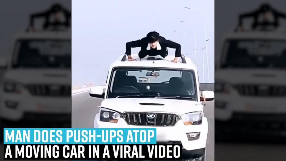 Man does push-ups atop a moving car in a viral video