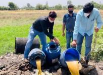 Sleuths of Excise Department destroying illicit liquor