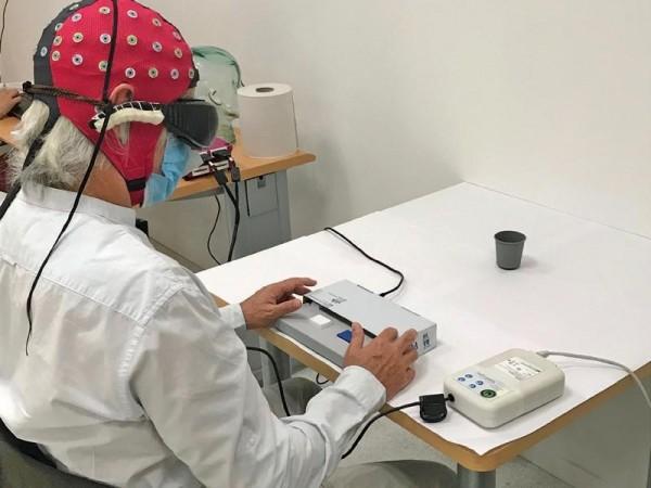A visual detection task from the study. The man is asked to determine the presence or absence of a black cup on the white desk Goggles