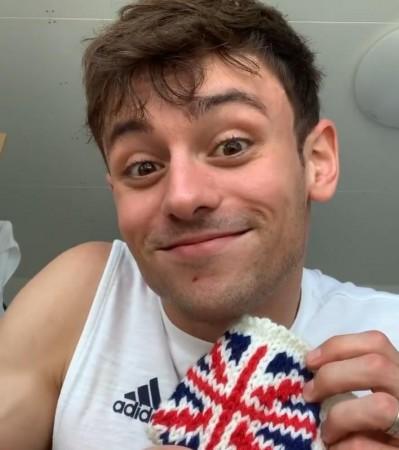 Diving champion Tom Daley with his knitted gold-medal case Diving champion Tom Daley with his knitted gold-medal case