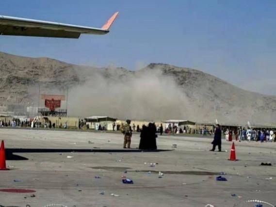 Photo taken with mobile phone shows smoke rises near the blast site at an airport in Kabul, Kabul bombings
