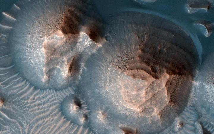 This image shows several craters in Arabia Terra that are filled with layered rock, often exposed in rounded mounds. The image was taken by a camera, the High Resolution Imaging Experiment, on NASA's Mars Reconnaissance Orbiter / Credit: NASA/JPL-Caltech/University of Arizona Mars volcanoes