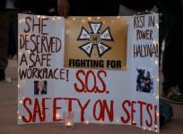 A woman displays a sign calling for workplace safety at a vigil for cinematographer Halyna Hutchins, who died after being accidentally shot by Alec Baldwin on the set of his movie 'Rust'.