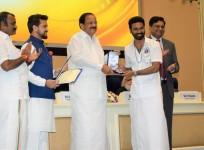 Actor Dhanush receiving the award from Vice President M. Venkaiah Naidu at Vigyan Bhavan