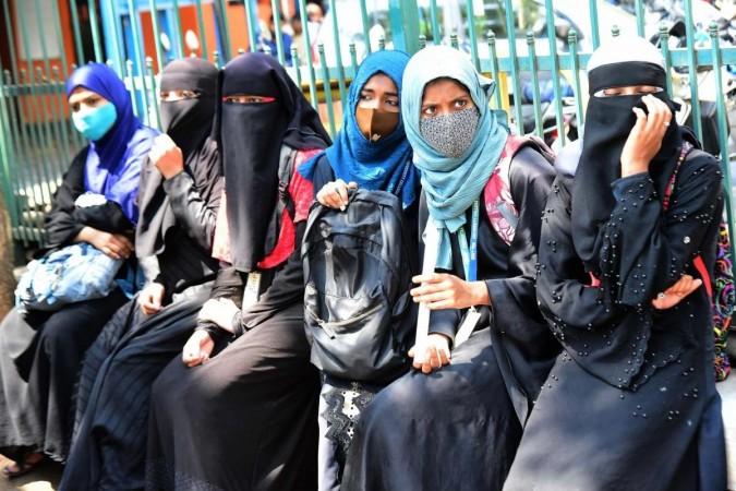 Muslim students wearing Hijab were stopped by policemen from entering Government PU College Yelahanka, amid Karnataka High Courts interim order restraining students from wearing religious symbols inside the classroom, in Bengaluru on Friday 18th February