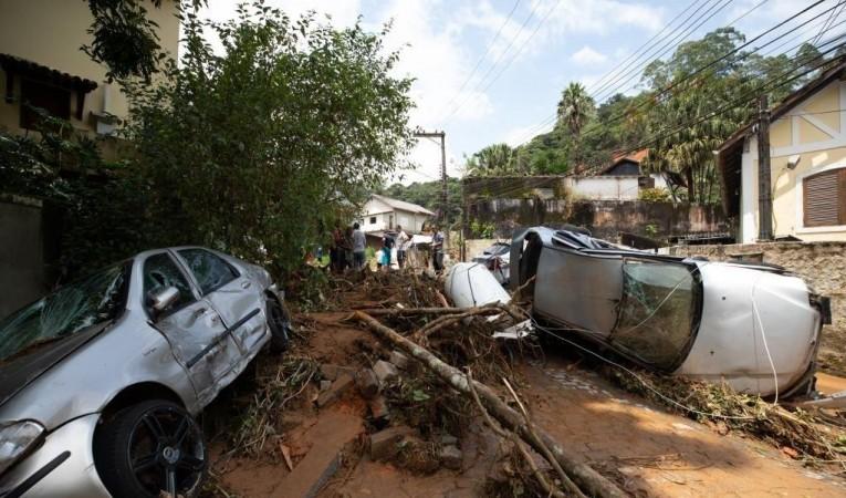 Damaged trees and vehicles block a road after heavy rains in Petropolis in the state of Rio de Janeiro, Brazil, Feb. 16, 2022. (Xinhua/Wang Tiancong/IANS)