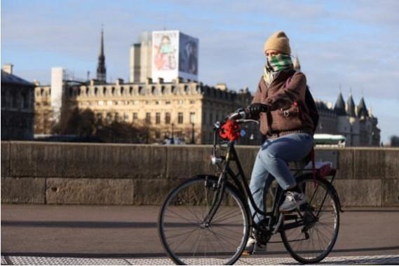 A woman rides a bike along the Seine River in Paris, France A woman rides a bike along the Seine River in Paris, France, Jan. 5, 2022. (Xinhua/Gao Jing/IANS)