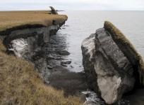 Thawing permafrost can result in the loss of terrain, as seen in this image where part of the coastal bluff along Drew Point, Alaska, has collapsed into the ocean. Credit: Benjamin Jones, USGS