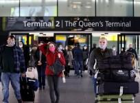 A passenger walks past a public health notice in Heathrow Airport in London, Britain.
