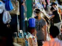 A woman wearing a face mask is seen at a market in Manila, the Philippines