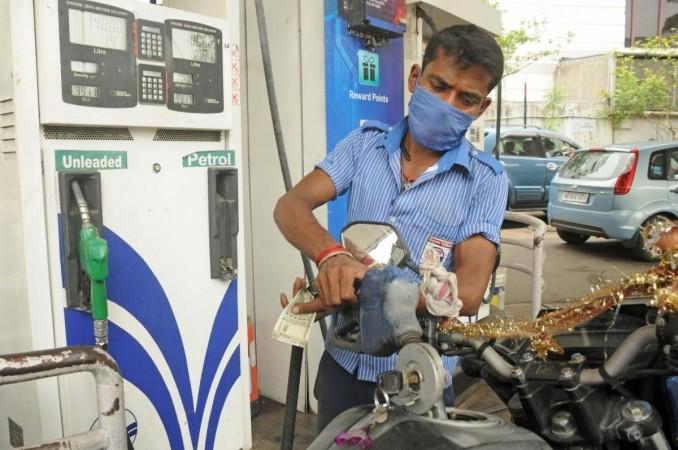 An employee refills petrol in a vehicle at a petrol pump (File photo) An employee refills petrol in a vehicle at a petrol pump (File photo)