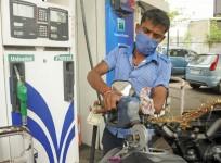 An employee refills petrol in a vehicle at a petrol pump (File photo)