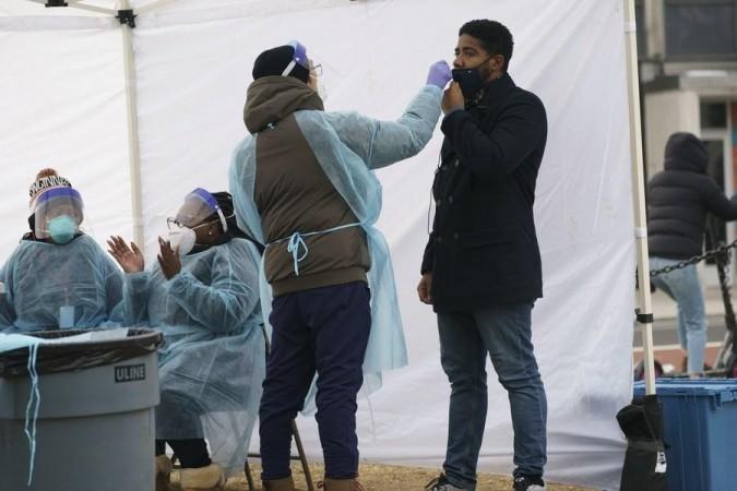 A medical worker takes a nasal swab sample from a man for COVID-19 testing in Washington, D.C., the United States, on Jan. 13, 2022. A medical worker takes a nasal swab sample from a man for COVID-19 testing in Washington, D.C., the United States, on Jan. 13, 2022.