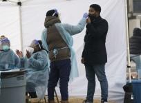 A medical worker takes a nasal swab sample from a man for COVID-19 testing in Washington, D.C., the United States, on Jan. 13, 2022.
