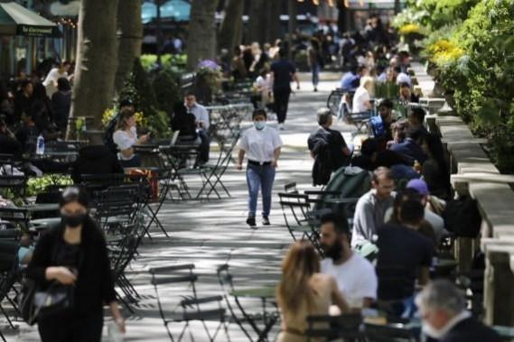 A woman with mask walks through Bryant Park in New York(File Photo) A woman with mask walks through Bryant Park in New York