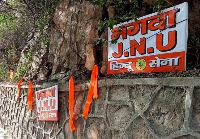 New Delhi: Saffron board written with 'Bhagwa JNU' and saffron flags put outside the JNU University campus by Hindu Sena, in New Delhi on Friday April 15, 2022. JNU