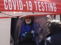 A medical worker collects a swab sample from a person at a COVID-19 testing site on Times Square in New York, the United States, March 29, 2022.