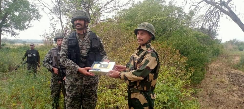 BSF and Pakistani Rangers exchanging sweets on the occasion of Eid BSF and Pakistani Rangers