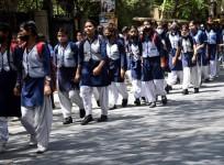School students are on their way home after school in New Delhi on April 1, 2022.