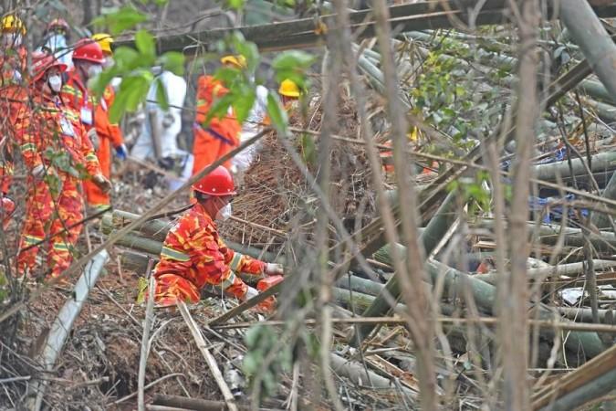 Photo taken with a mobile phone shows rescuers searching for the black boxes at a plane crash site in Tengxian County, south China's Guangxi Zhuang Autonomous Region, March 22, 2022. Photo taken with a mobile phone shows rescuers searching for the black boxes at a plane crash site in Tengxian County, south China's Guangxi Zhuang Autonomous Region, March 22, 2022.
