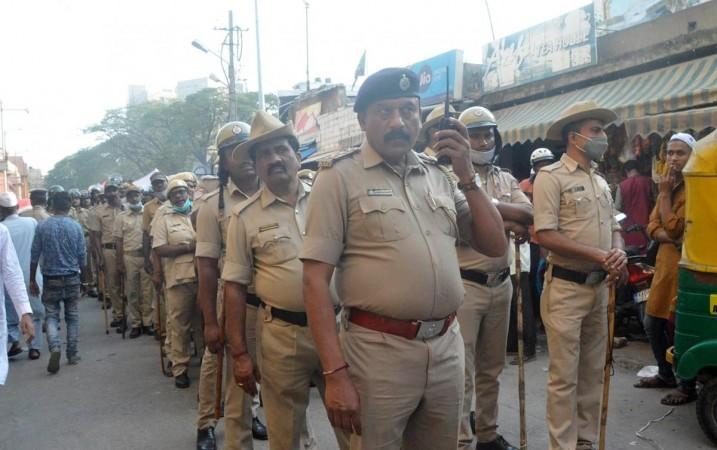 Bengaluru:Police take out a flag march in Shivajinagar area ahead of Eid Ul Fitr festival at Shivaji Nagar,in Bengaluru on Monday 2nd May 2022 Bengaluru:Police