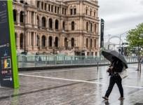 People wearing masks walk in Brisbane, Australia,