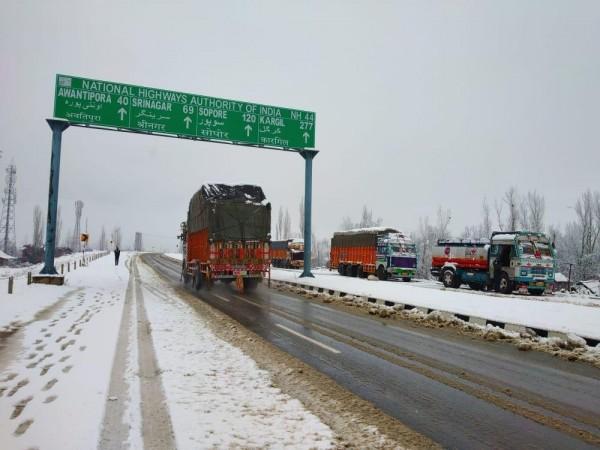 Heavy motor vehicles standard at Qazigund after fresh Snowfall in Srinagar jammu National highway road Heavy vehicles