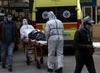 Health workers transfer a patient