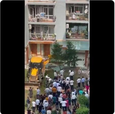 Residents cheer as the construction against Shrikant Tyagi's house is being brought down JCB