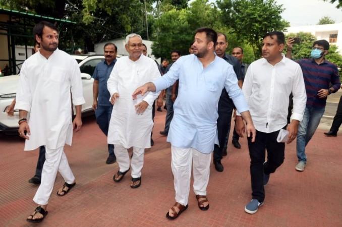 Patna: JDU party leader Nitish Kumar with RJD leaders Tejashwi Yadav and Tej Pratap Yadav after resigning from the post of Chief Minister of Bihar and breaking alliance with BJP, in Patna on Tuesday, Aug 09, 2022. (Photo: IANS) Nitish Kumar with RJD leaders Tejashwi Yadav and Tej Pratap Yadav