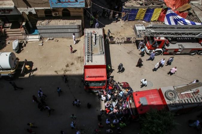 Cairo : Security personnel stand at the cordoned scene where a massive fire broke out during a Sunday service at the Abu Sefein Coptic church in Giza on 14 August 2022. At least 41 people have died and dozens were severely injured after a mass fire broke out at the Coptic church. Massive fire broke out during a Sunday service at the Abu Sefein Coptic church in Giza
