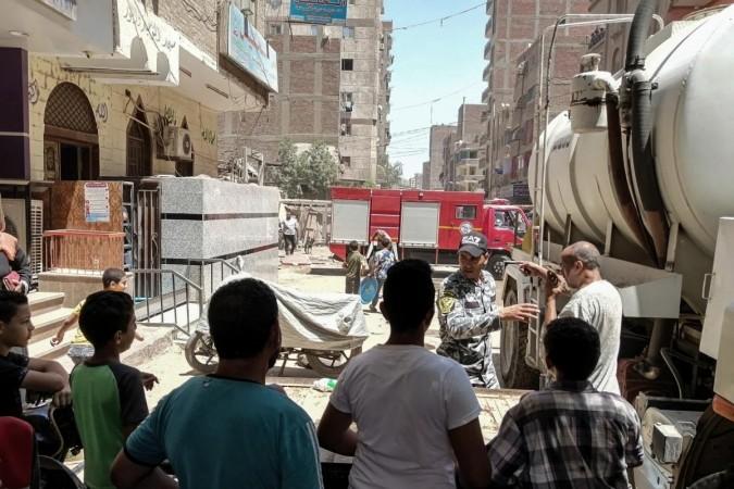 Cairo : Security personnel stand at the cordoned scene where a massive fire broke out during a Sunday service at the Abu Sefein Coptic church in Giza on 14 August 2022. At least 41 people have died and dozens were severely injured after a mass fire broke out at the Coptic church. Massive fire broke out during a Sunday service at the Abu Sefein Coptic church in Giza