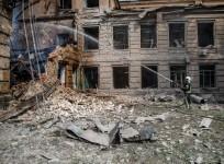 26 August 2022, Ukraine, Slovyansk: A rescue worker extinguishes a fire caused by an overnight shelling at the Slovyansk Chemical Mechanical College