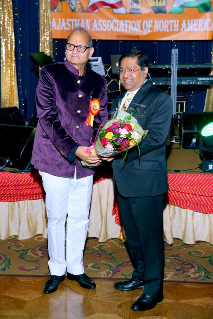RANA president and Jaipur Foot USA Chairman Prem Bhandari gives a bouquet of flowers to CGI NY Randhir Jaiswal at annual gala event