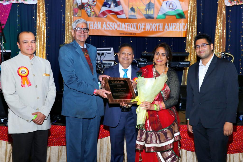 D R Mehta giving award and flowers to Dr Subha Jain on behalf of Dr Vijay Arya Deep Chopre, BOD RANA, and her son.