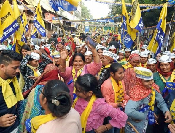 New Delhi: AAP workers hold party flags dance during AAP National Convenor and Delhi Chief Minister Arvind Kejriwal's roadshow for the upcoming MCD elections, in New Delhi on Wednesday, November 30, 2022. AAP workers hold party flags dance during AAP National Convenor