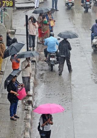 People use umbrellas during light rainfall, in Bengaluru on Thursday, Nov. 24, 2022. People use umbrellas during light rainfall, in Bengaluru on Thursday, Nov. 24, 2022.