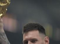 Lusail:Argentina's Lionel Messi celebrates with the trophy after winning the World Cup final soccer match between Argentina and France at the Lusail Stadium in Lusail, Qatar, Sunday, Dec.18, 2022