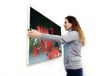 This wireless TV sans remote sticks to wall without a mount.