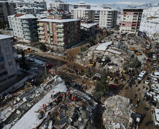 This aerial photo taken on Feb. 8, 2023 shows rescuers searching for survivors among the rubble of buildings destroyed in quake-hit Besni District of Adiyaman Province, Turkey.