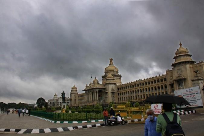 Dark clouds hover over the Vidhana Soudha during a monsoon season in Bengaluru.