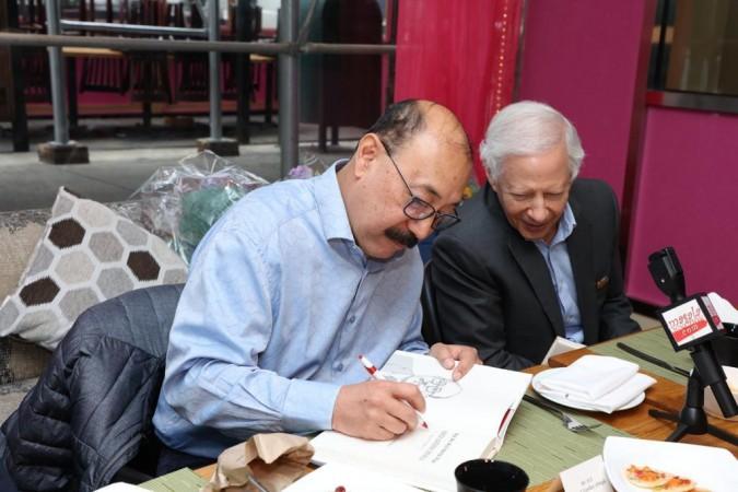 Shringla signing a copy of the book for Kenneth Juster. Shringla signing a copy of the book for Kenneth Juster.