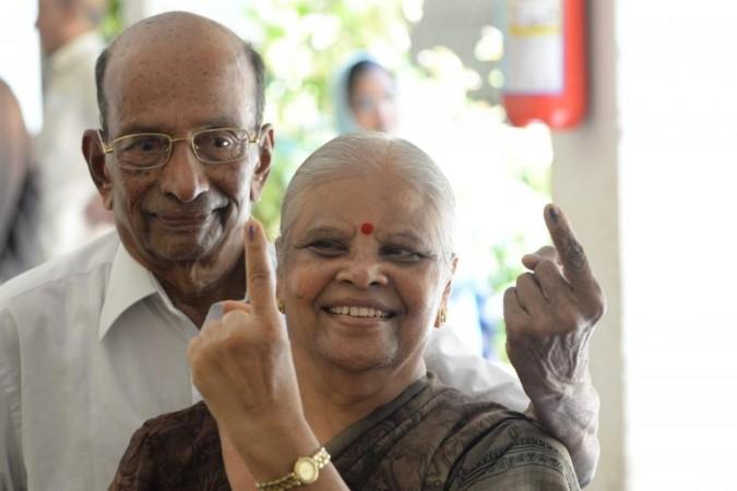 File: An elderly couple show the mark of inedible ink after casting votes in Bengaluru on April 18, 2019. (Photo: IANS) voting