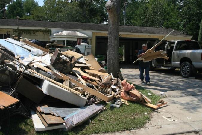 HOUSTON, Sept. 4, 2017 (Xinhua) -- A man dumps debris of his house flooded in Dickinson, Texas, the United States, on Sept. 2, 2017. In Dickinson, more than 50 percent of homes sustained heavy damage due to Harvey, county officials said. More than 60 people have died or are feared dead in flooding or circumstances connected to Tropical Storm Harvey, according to local officials on Monday. house collapsed