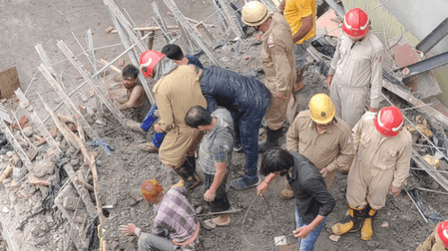 Two persons were rescued while another is still trapped under the debris after an under construction building collapsed in South Delhi's Dakshinpuri area on Thursday, the police said. Two persons were rescued while another is still trapped under the debris after an under construction building collapsed in South Delhi's Dakshinpuri area on Thursday, the police said.